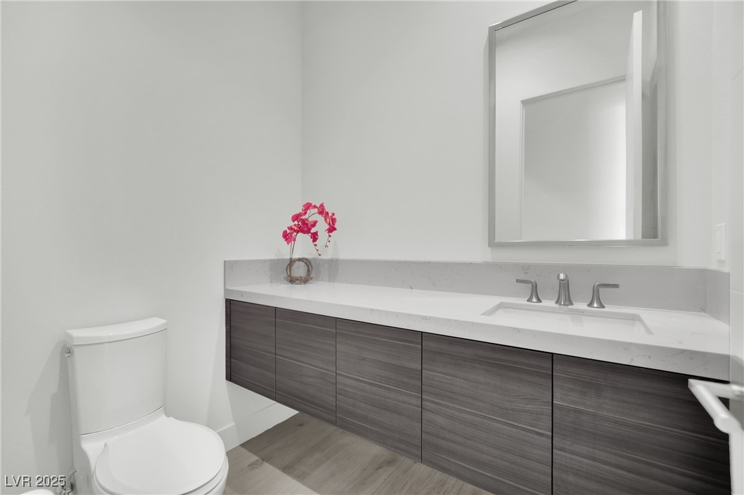658 Falcon Summit Court Henderson, NV 89012 - Photo 48 of 99 Half bath with vanity and light wood finished floors