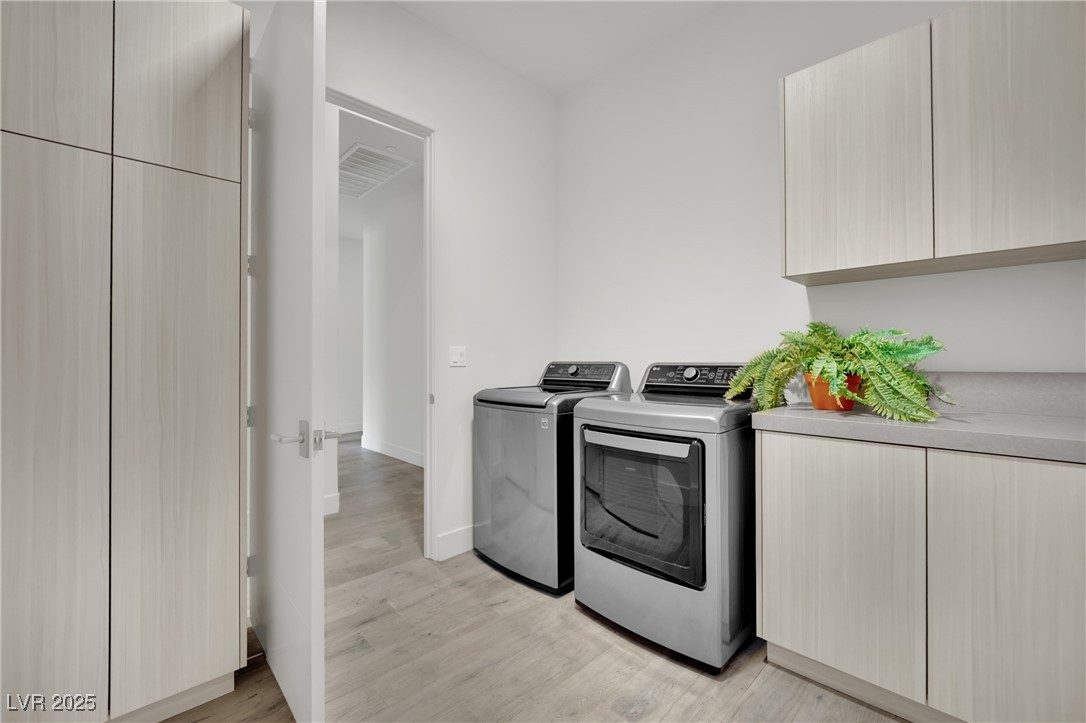 658 Falcon Summit Court Henderson, NV 89012 - Photo 49 of 99 Laundry area with cabinet space, light wood-style floors, and separate washer and dryer