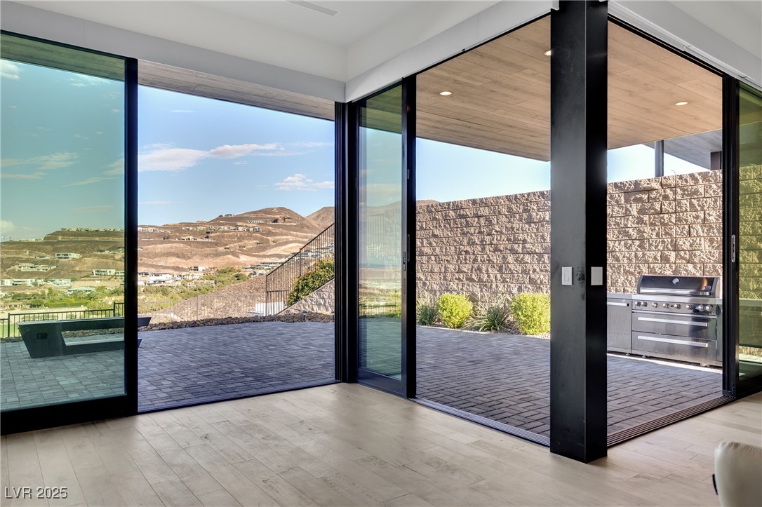 658 Falcon Summit Court Henderson, NV 89012 - Photo 58 of 99 Doorway with expansive windows, wood finished floors, and recessed lighting