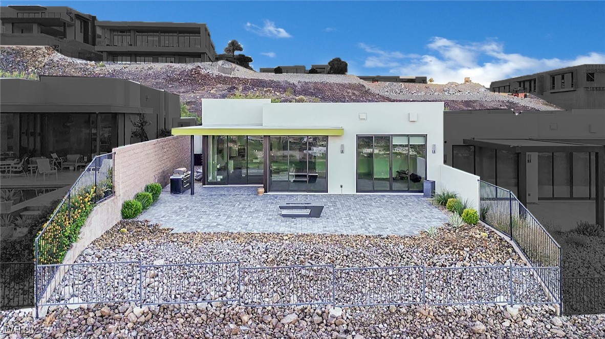 658 Falcon Summit Court Henderson, NV 89012 - Photo 67 of 99 Back of property with a sunroom, a patio, and stucco siding