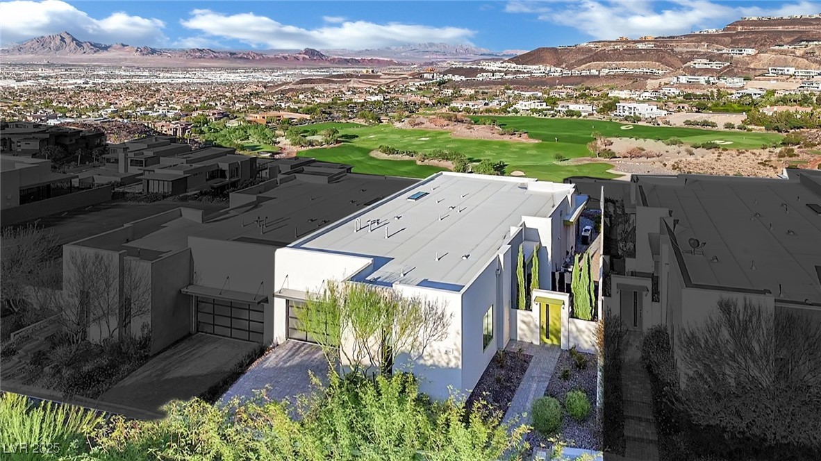 658 Falcon Summit Court Henderson, NV 89012 - Photo 74 of 99 Aerial view of residential area with a mountain backdrop and a golf club