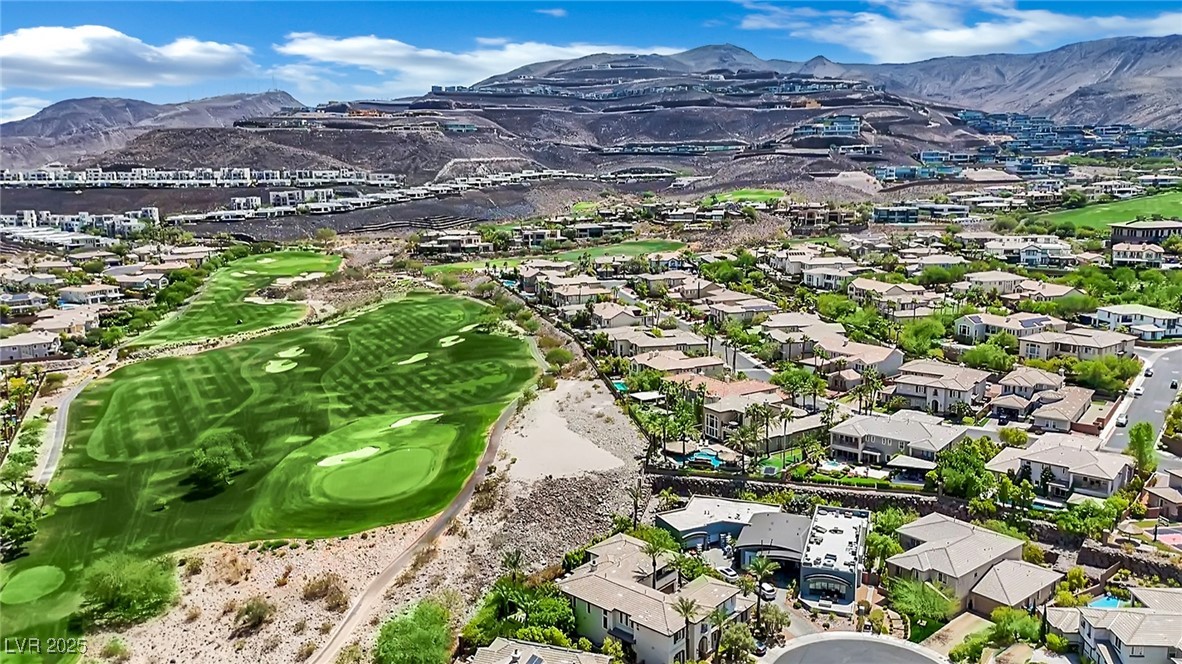 658 Falcon Summit Court Henderson, NV 89012 - Photo 77 of 99 Aerial overview of property's location featuring a mountainous background, nearby suburban area, and a local golf course