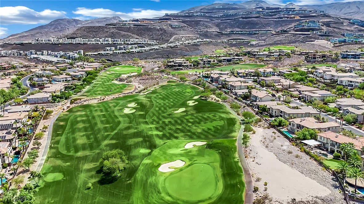 658 Falcon Summit Court Henderson, NV 89012 - Photo 86 of 99 Aerial view of residential area with a mountain backdrop and a golf club