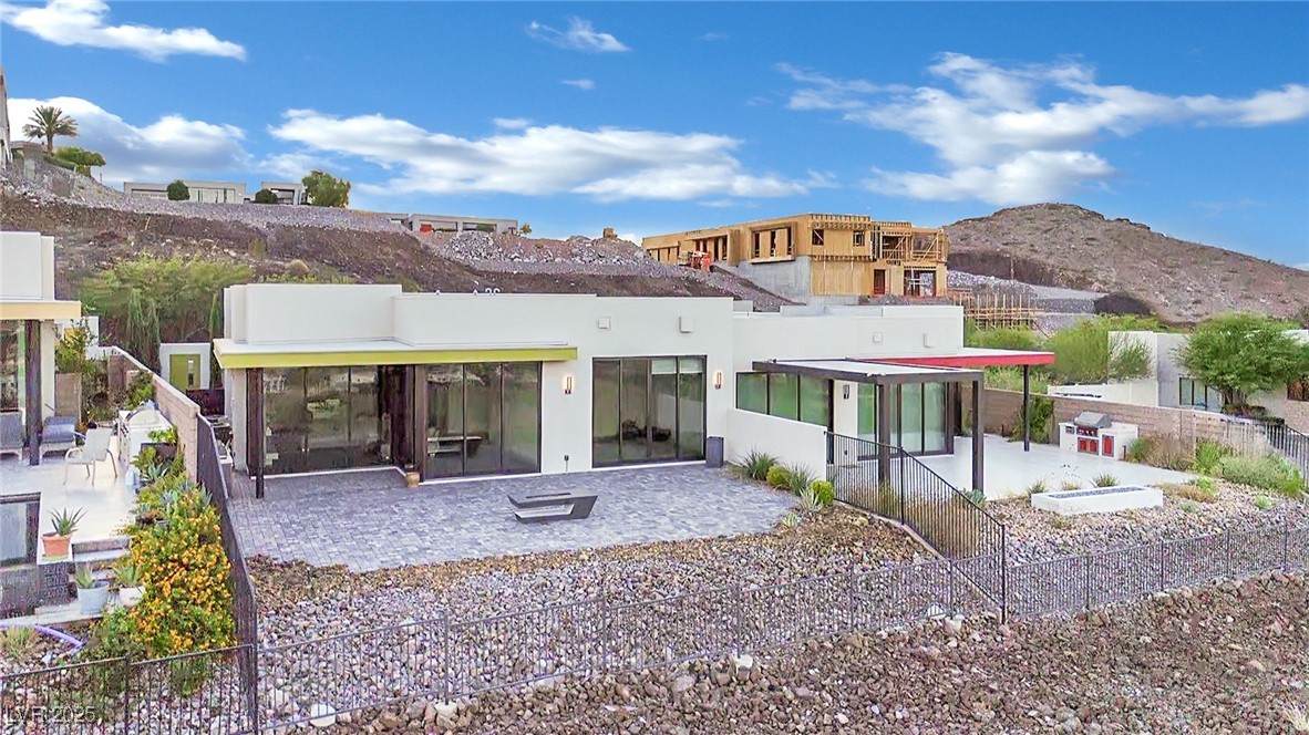 658 Falcon Summit Court Henderson, NV 89012 - Photo 87 of 99 Back of house with a patio, a mountain view, and stucco siding