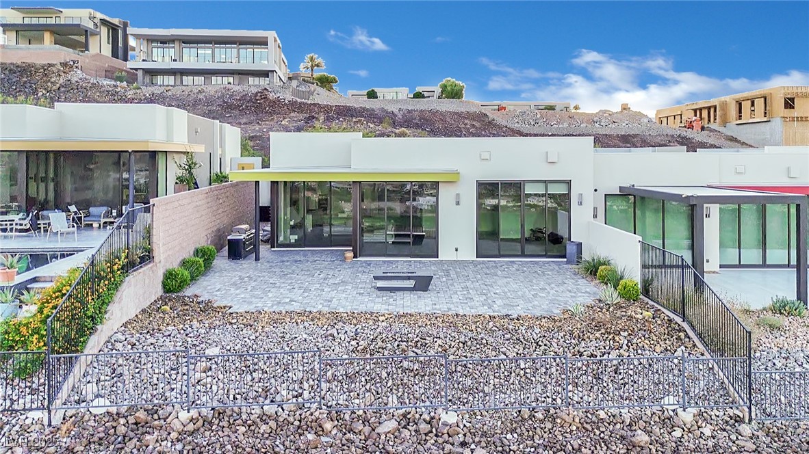 658 Falcon Summit Court Henderson, NV 89012 - Photo 88 of 99 Back of property with a patio area, a fenced backyard, and stucco siding