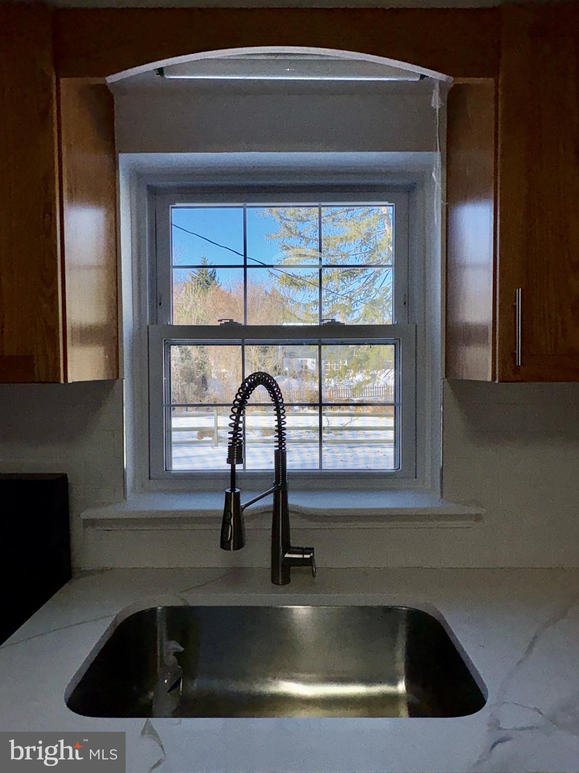 724 Brook Drive Newark, DE 19713 - Photo 12 of 37 a kitchen with a sink a window and cabinets