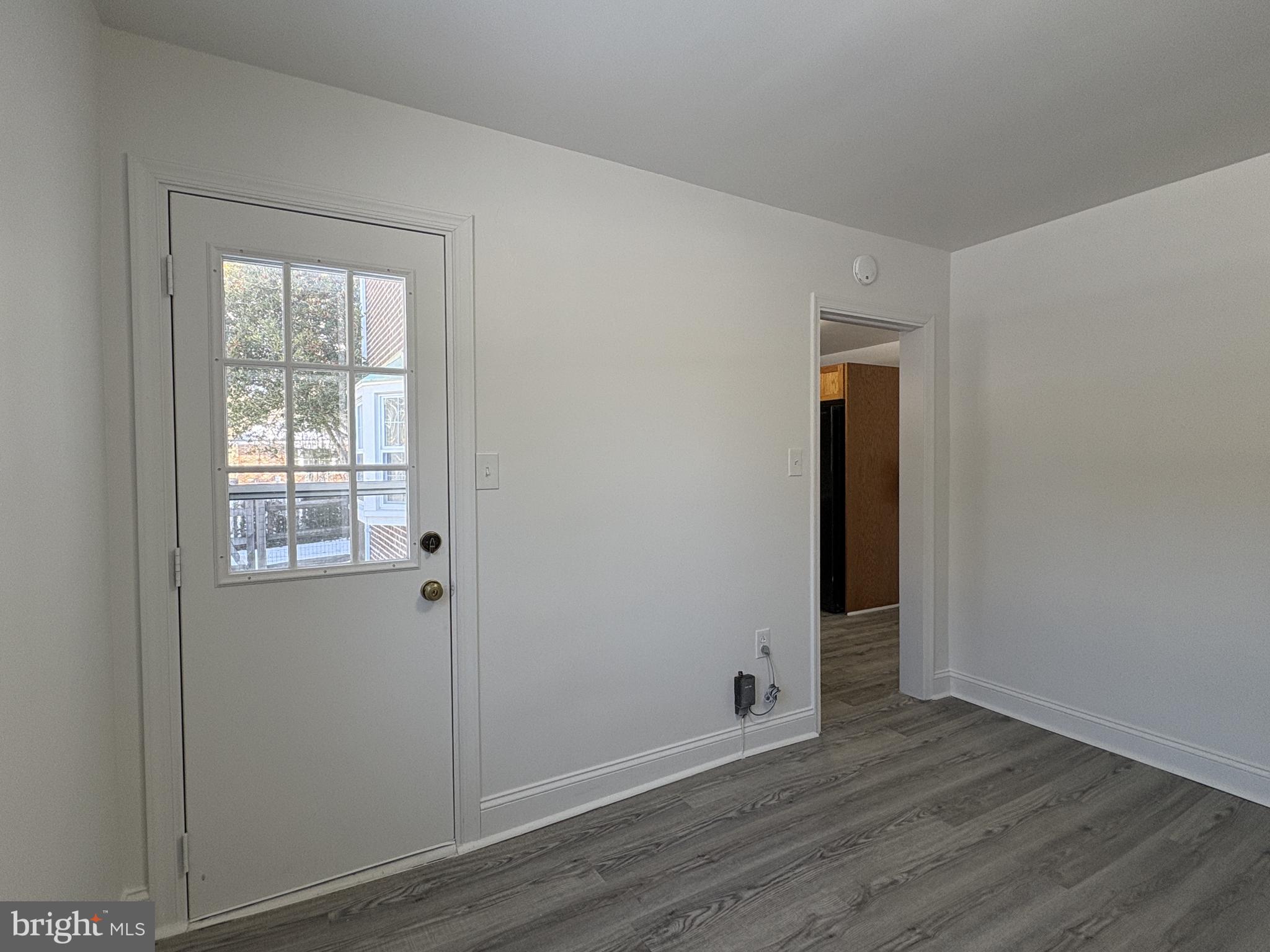 724 Brook Drive Newark, DE 19713 - Photo 18 of 37 an empty room with wooden floor and windows