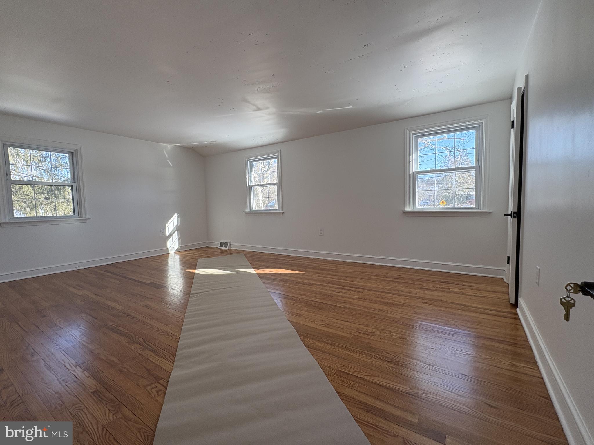 724 Brook Drive Newark, DE 19713 - Photo 26 of 37 a view of an empty room with window and wooden floor