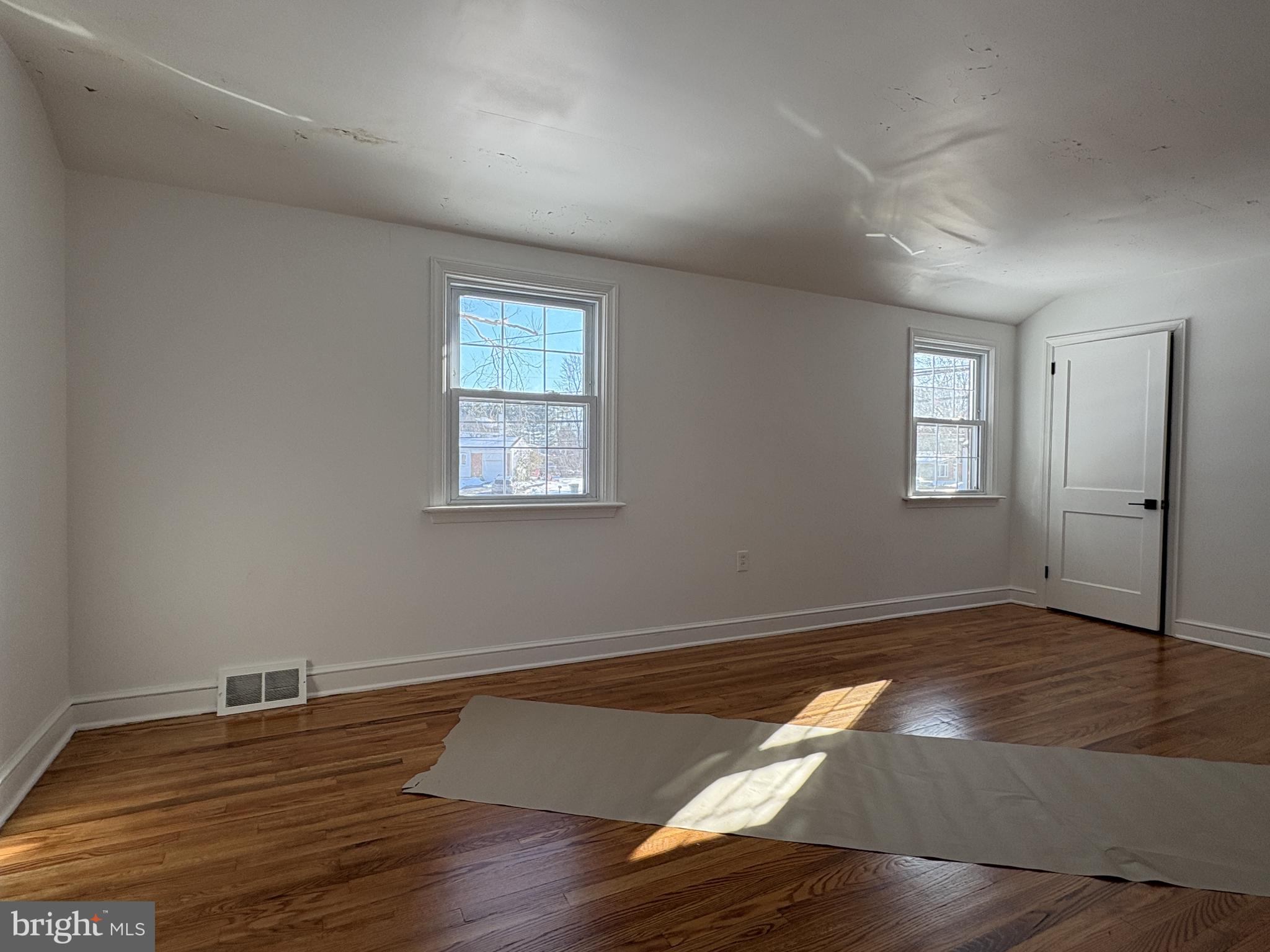 724 Brook Drive Newark, DE 19713 - Photo 27 of 37 an empty room with wooden floor and windows
