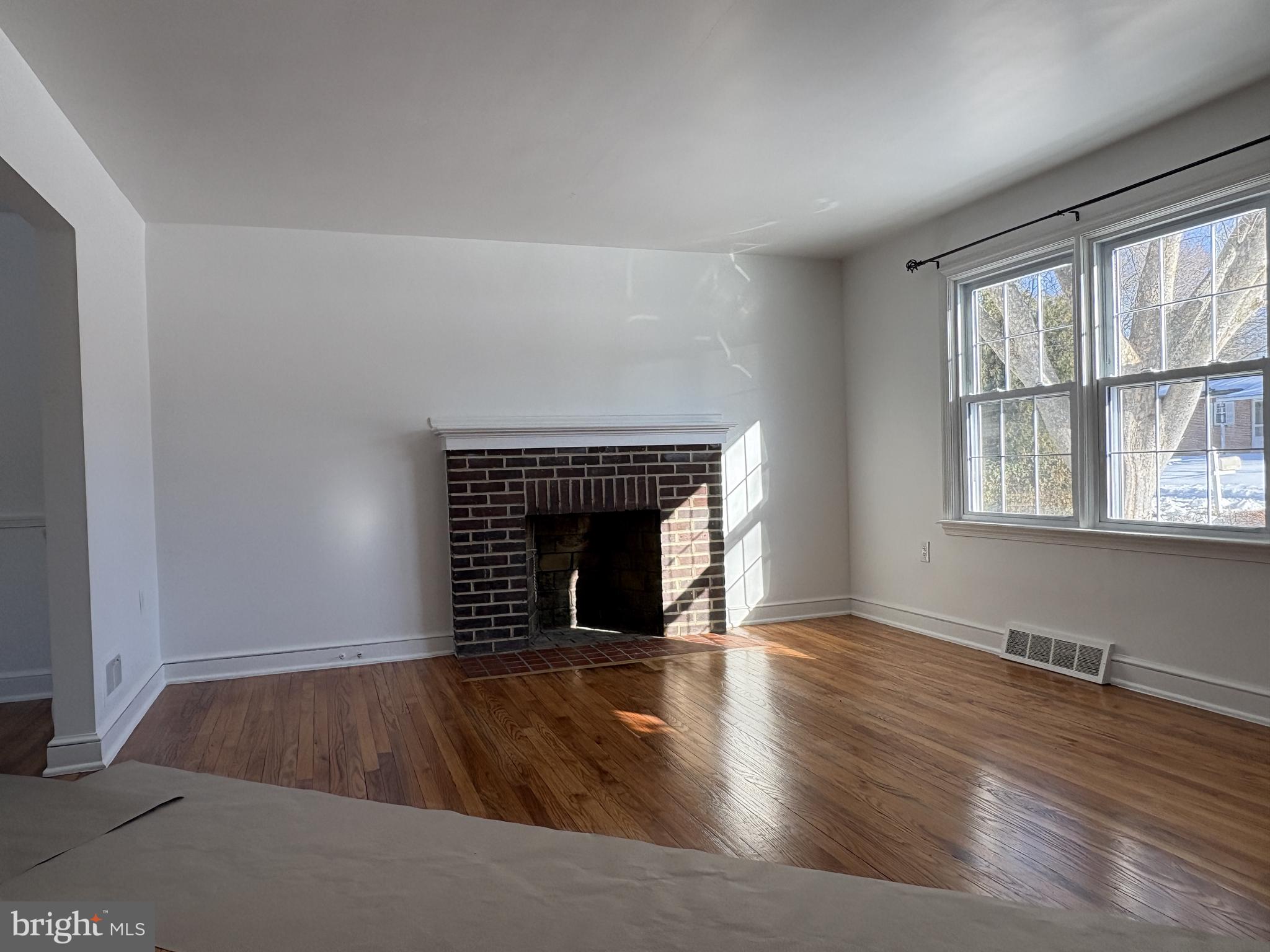 724 Brook Drive Newark, DE 19713 - Photo 3 of 37 a view of an empty room with wooden floor and a window