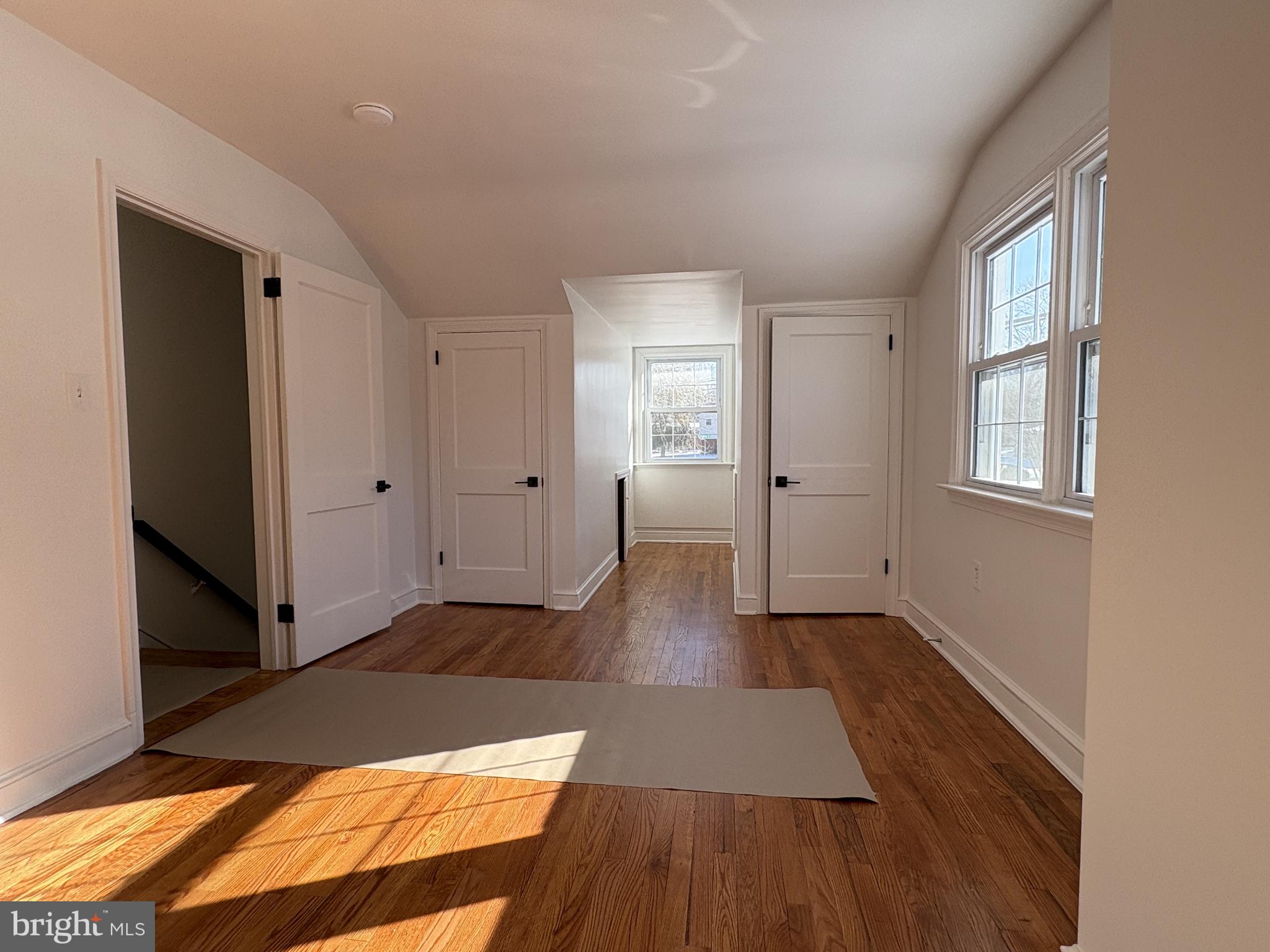 724 Brook Drive Newark, DE 19713 - Photo 33 of 37 an empty room with wooden floor and windows