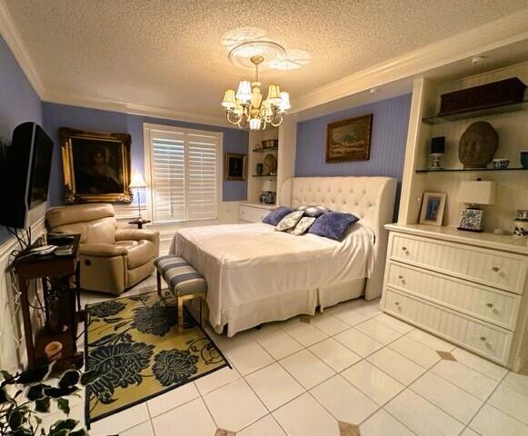 150 Cape Pointe Circle Jupiter, FL 33477 - Photo 15 of 22 a bedroom with a bed a dresser and flat screen tv