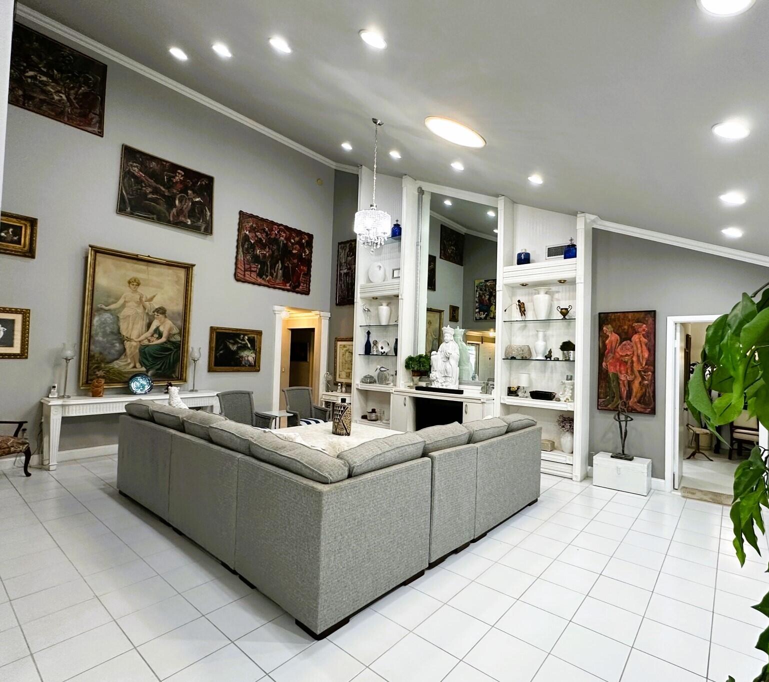 150 Cape Pointe Circle Jupiter, FL 33477 - Photo 4 of 22 a living room with furniture and a fireplace