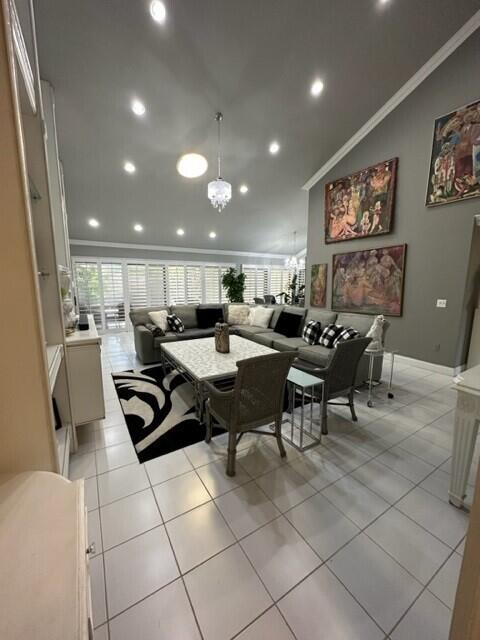 150 Cape Pointe Circle Jupiter, FL 33477 - Photo 5 of 22 a group of people sitting in a room with kitchen island