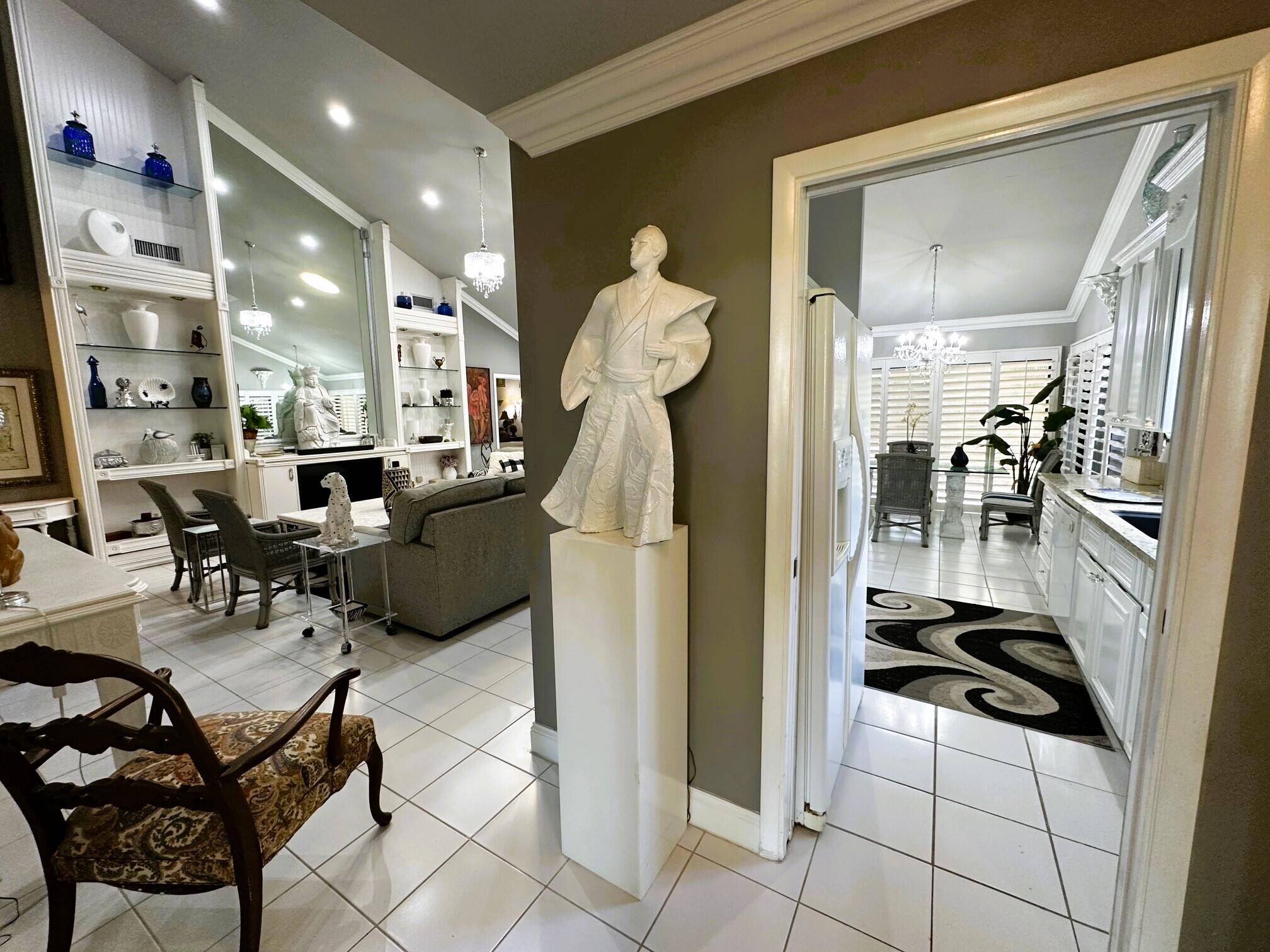 150 Cape Pointe Circle Jupiter, FL 33477 - Photo 6 of 22 a living room with furniture and a chandelier