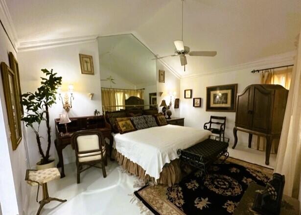 150 Cape Pointe Circle Jupiter, FL 33477 - Photo 8 of 22 a bed room with furniture and a mirror