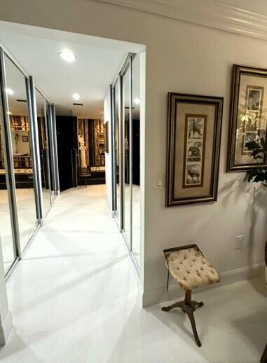 150 Cape Pointe Circle Jupiter, FL 33477 - Photo 10 of 22 a hallway with furniture and a large mirror