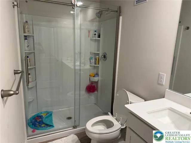 a bathroom with a toilet and a shower