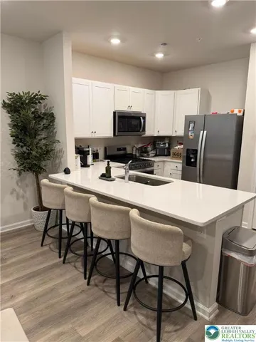 a kitchen with a dining table chairs and a potted plant