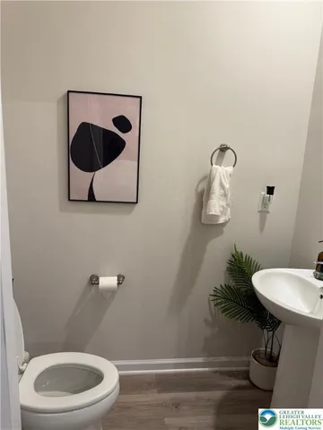a bathroom with a toilet a sink and mirror