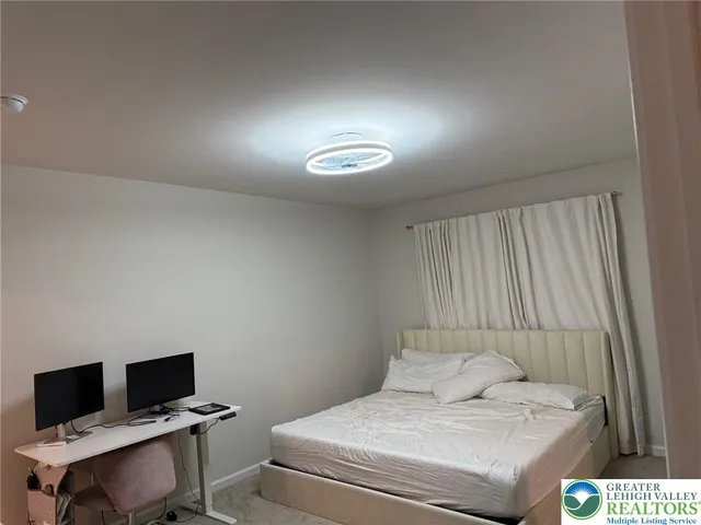 a bedroom with a bed and a desk