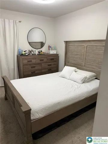 a bedroom with a bed and a dresser