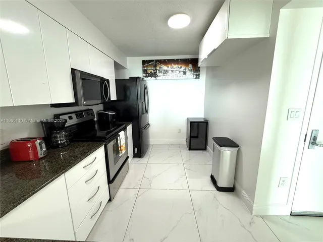 a kitchen with a sink a stove and a refrigerator