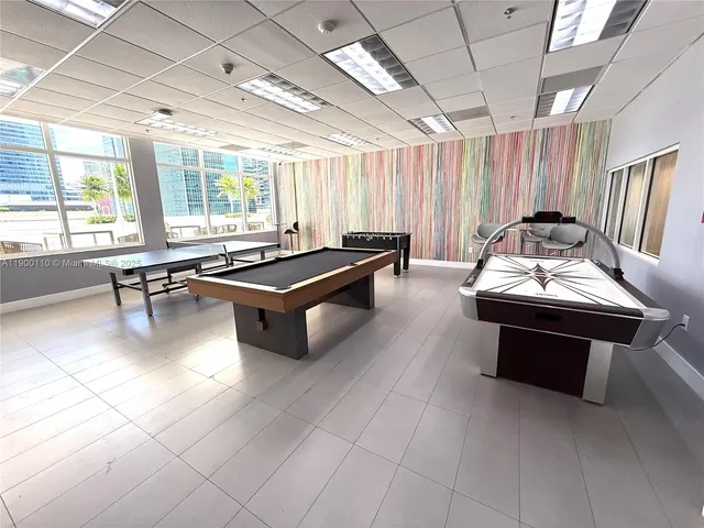 a living room with furniture a window and a chandelier