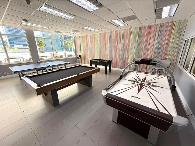 a living room with stainless steel appliances kitchen island furniture and a fireplace