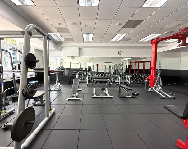 a gym room with lots of gym equipment