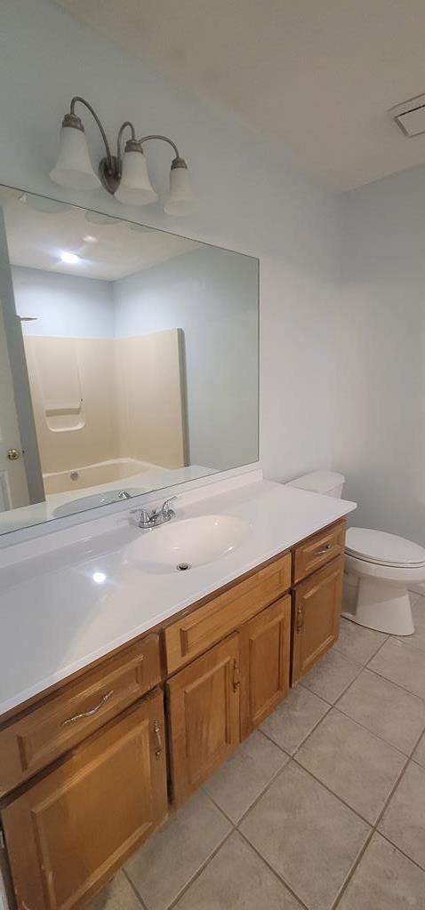 798 Omega Drive Columbus, GA 31907 - Photo 12 of 14 a bathroom with a sink a toilet and a mirror