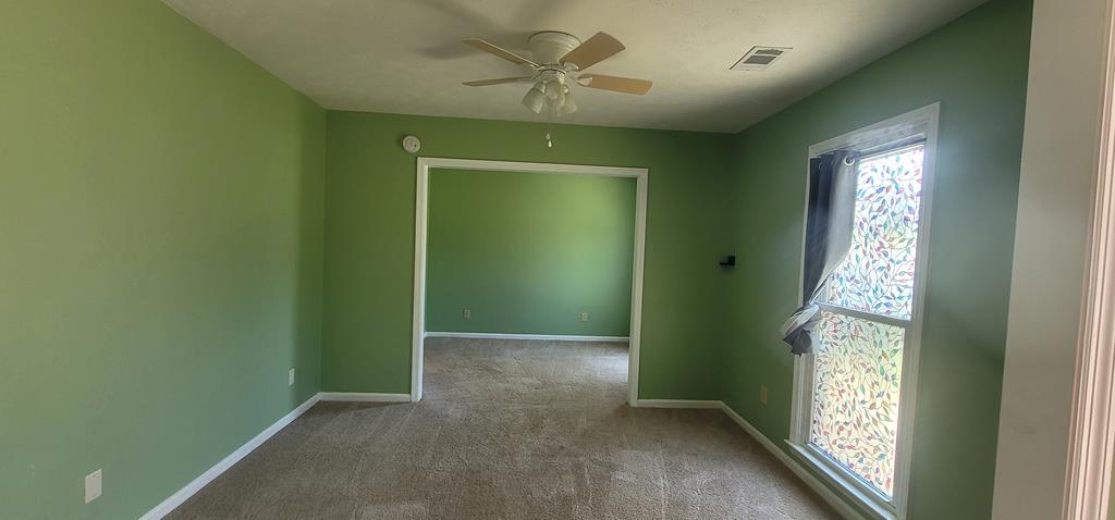 798 Omega Drive Columbus, GA 31907 - Photo 3 of 14 a view of an empty room with windows and chandelier fan