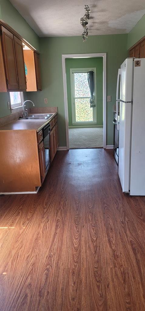 798 Omega Drive Columbus, GA 31907 - Photo 5 of 14 an empty room with a fireplace cabinet and wooden floor