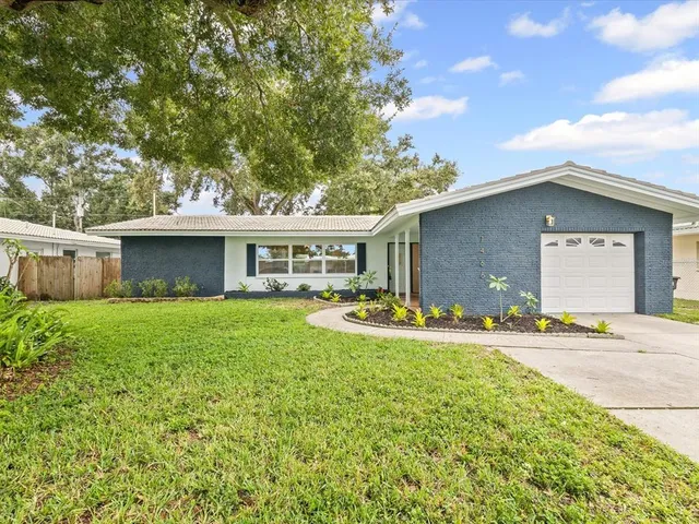 a front view of house with yard and outdoor seating