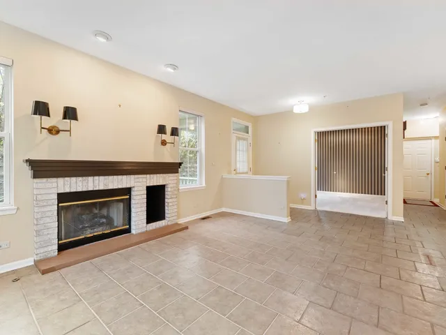 a view of a livingroom with a fireplace and window