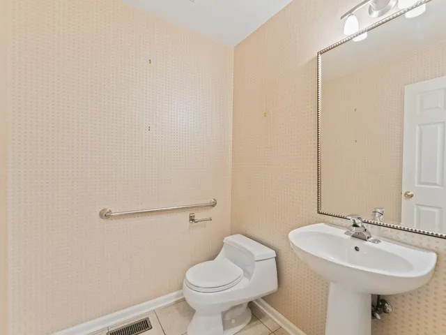 a bathroom with a sink toilet and a mirror