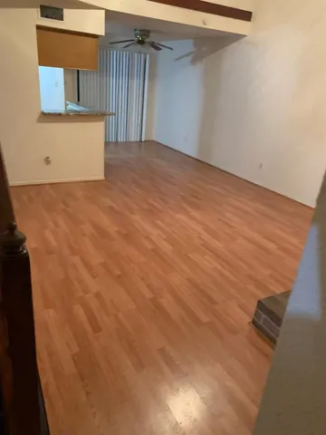 a view of a room with wooden floor