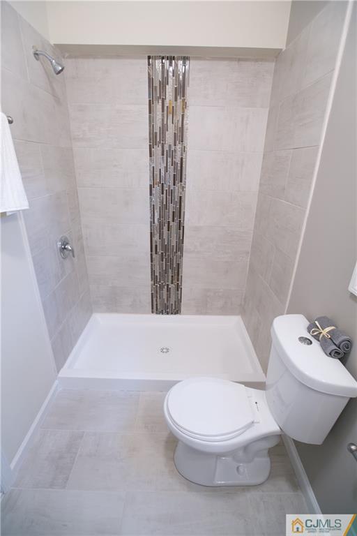 6 Brookside Road Edison, NJ 08817 - Photo 14 of 24 a bathroom with a white toilet sitting next to a white tub and shower