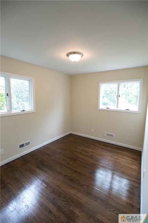 6 Brookside Road Edison, NJ 08817 - Photo 8 of 24 an empty room with wooden floor and windows