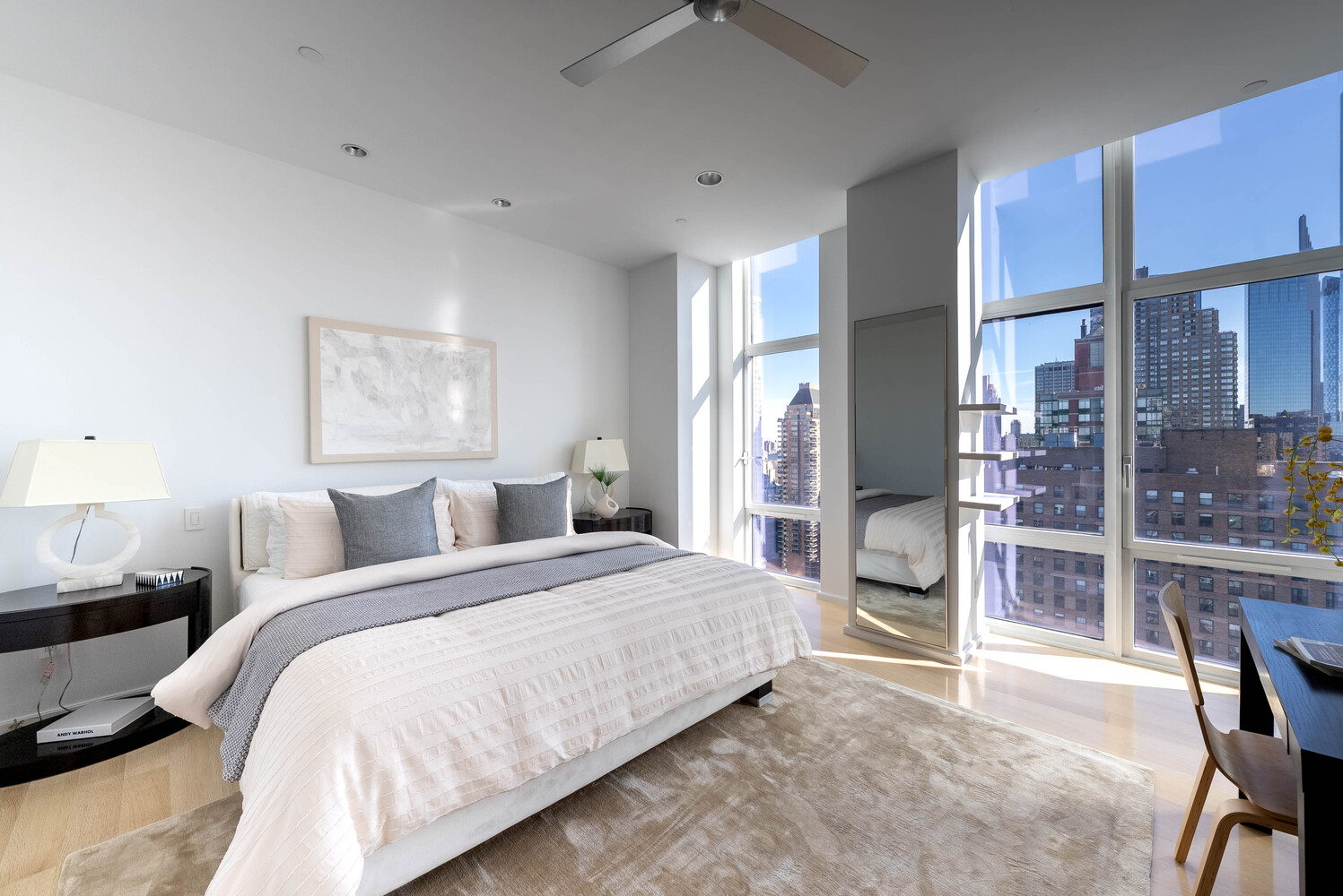 555 West 59th Street, Unit PHC Manhattan, NY 10019 - Photo 20 of 27 a bedroom with a large bed and a chandelier