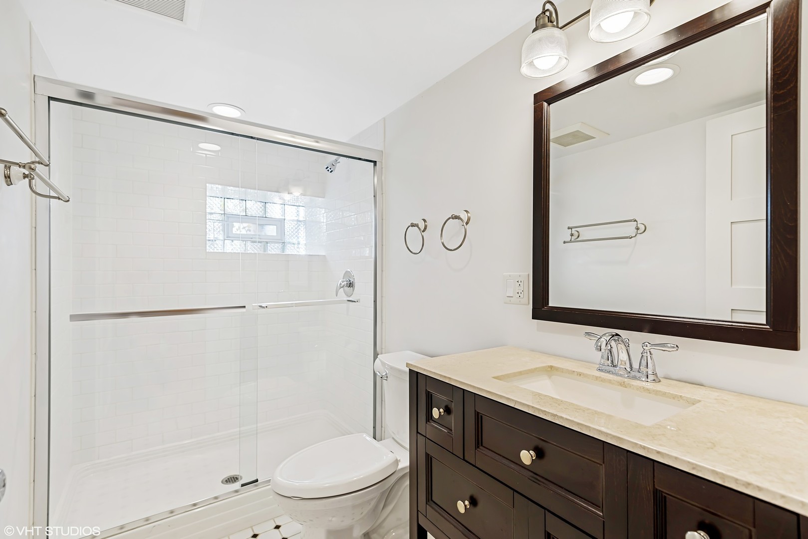 924 Sheridan Road Evanston, IL 60202 - Photo 22 of 34 a bathroom with a granite countertop sink toilet a mirror and shower