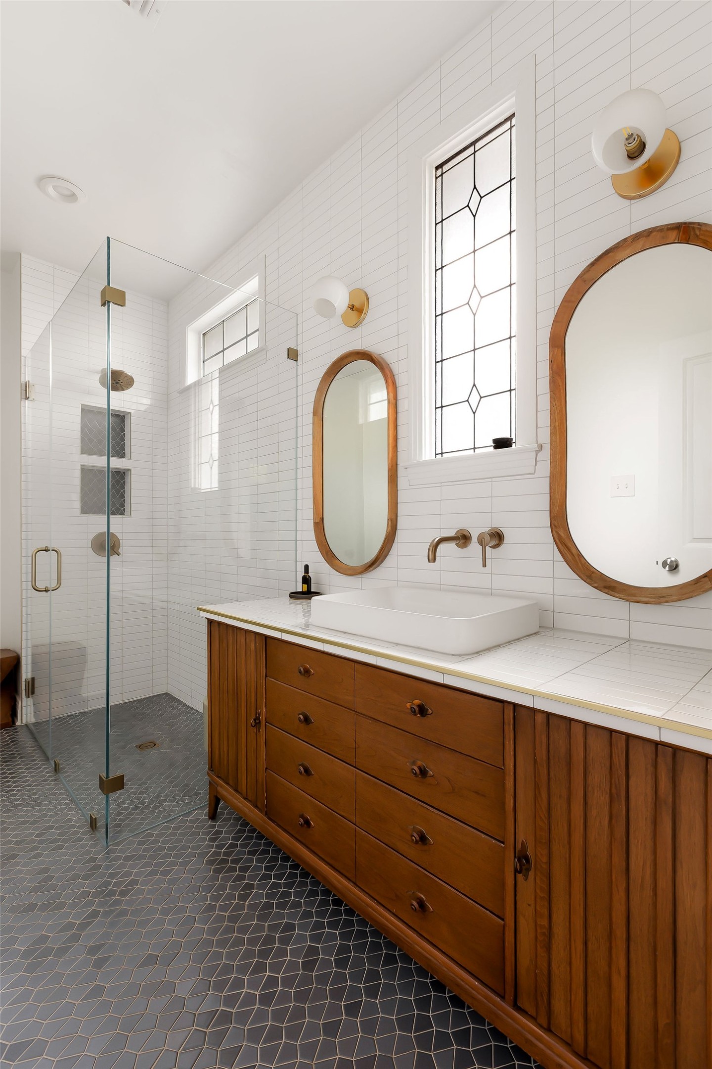 5108 Eilers Avenue Austin, TX 78751 - Photo 14 of 39 Beautifully updated primary bathroom with a walk-in shower. Vintage repurposed vanity