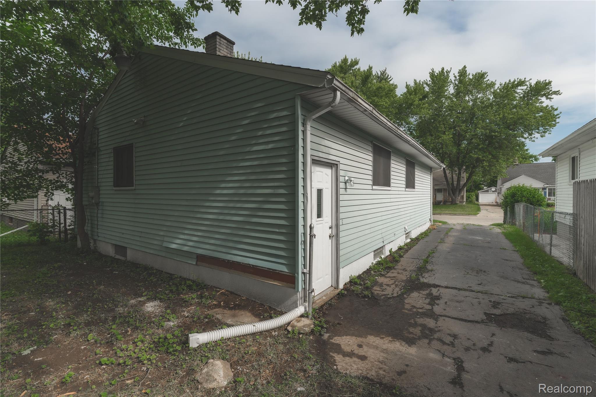 93 West Princeton Avenue Pontiac, MI 48340 - Photo 31 of 31 Light green siding exterior with a white entry door and two windows