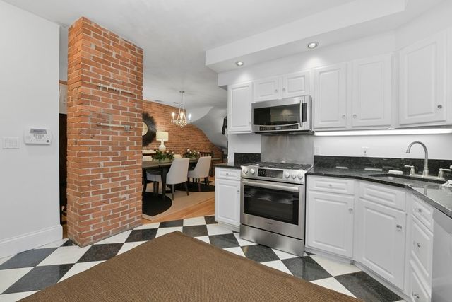 a kitchen with a sink cabinets and stainless steel appliances