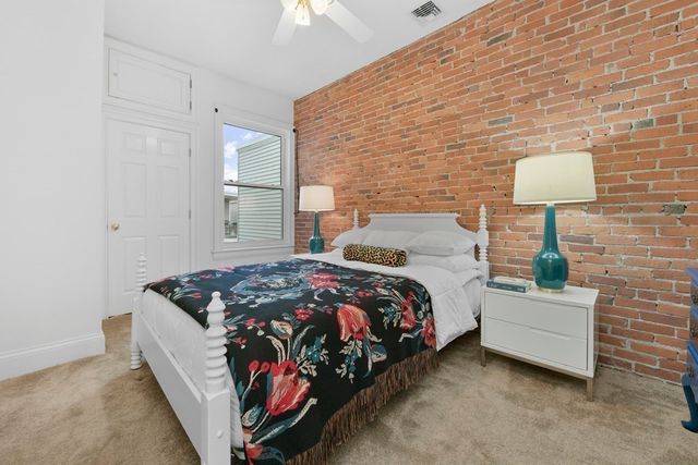 a bedroom with bed and a night stand