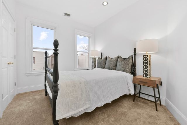 a bedroom with bed and a night stand