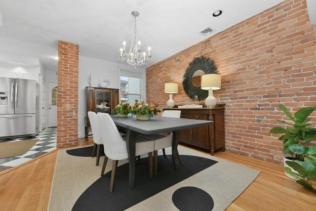 a view of a dining room with furniture and chandelier