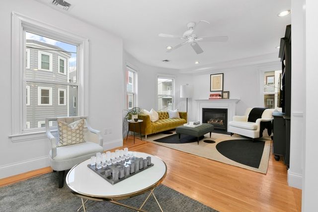 a living room with furniture couches and a fireplace