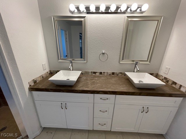 1237 Chrysler Street Lehigh Acres, FL 33974 - Photo 19 of 30 a bathroom with a sink and a mirror