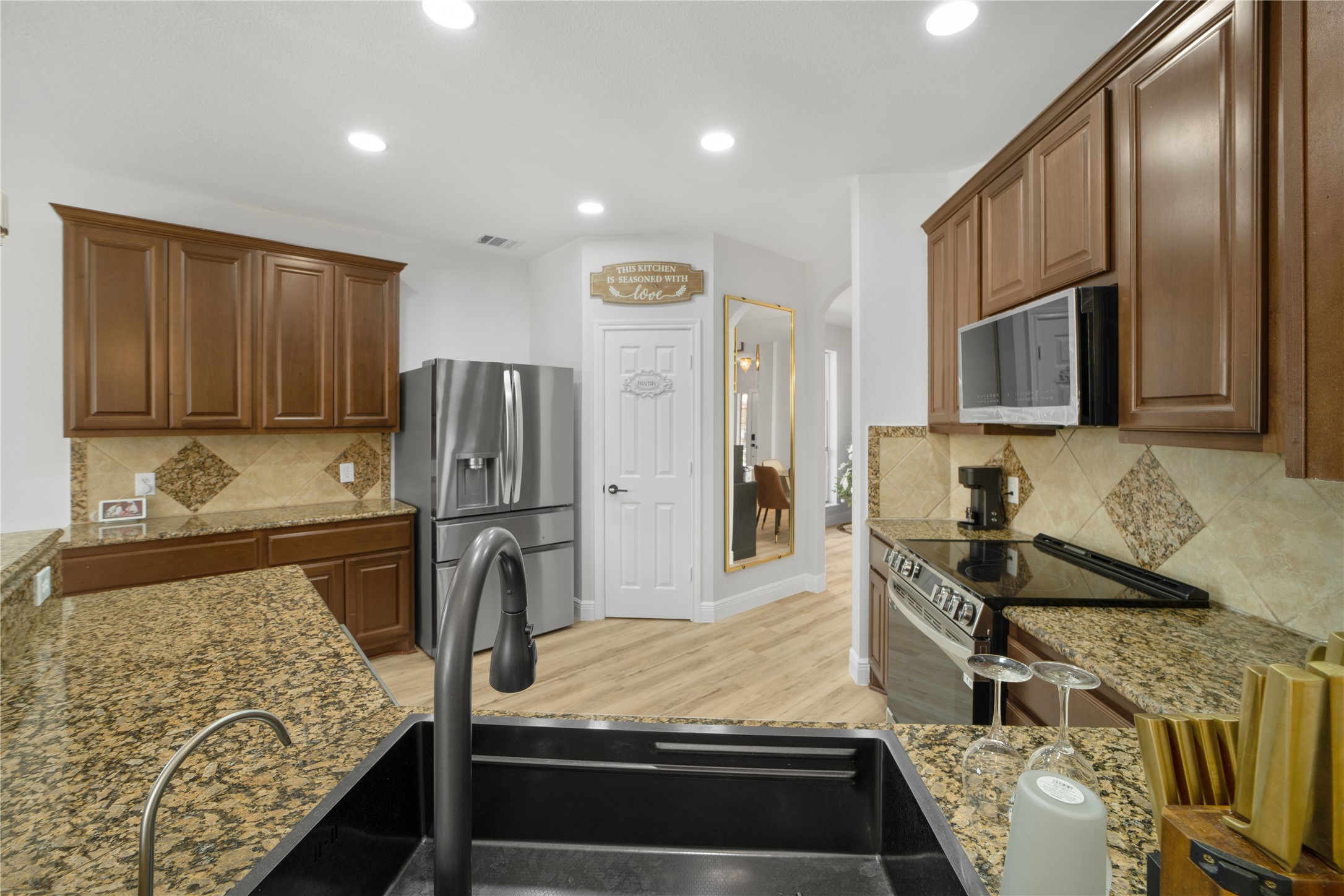 3032 Prairie Bluff Seguin, TX 78155 - Photo 23 of 23 Kitchen featuring arched walkways, stainless steel appliances, light stone countertops, decorative backsplash, and recessed lighting